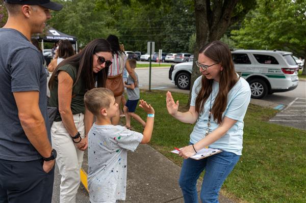 teaher and student doing a high five